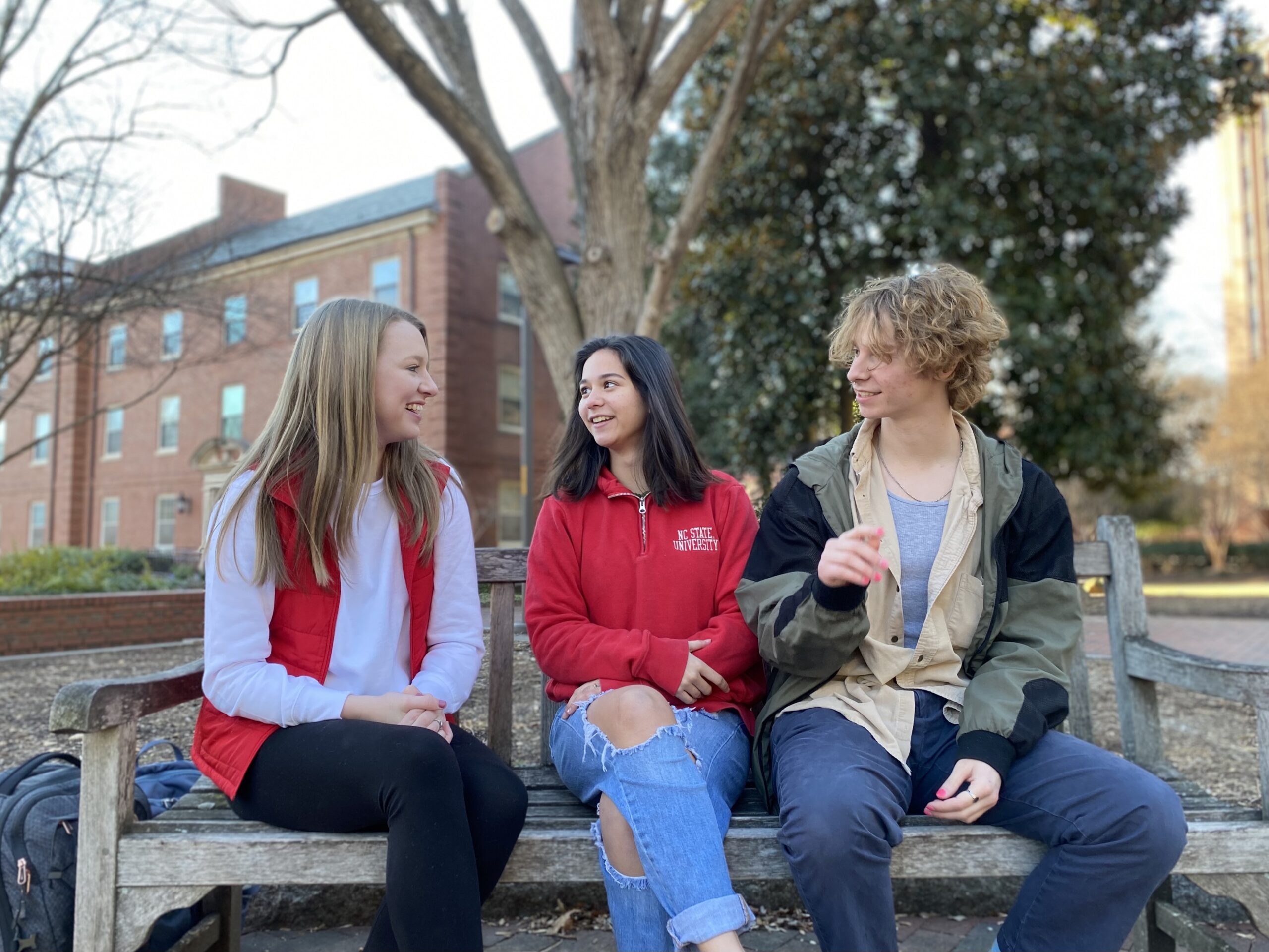 Mental Health Ambassadors chat on a bench near the Copper Wolves at Talley.