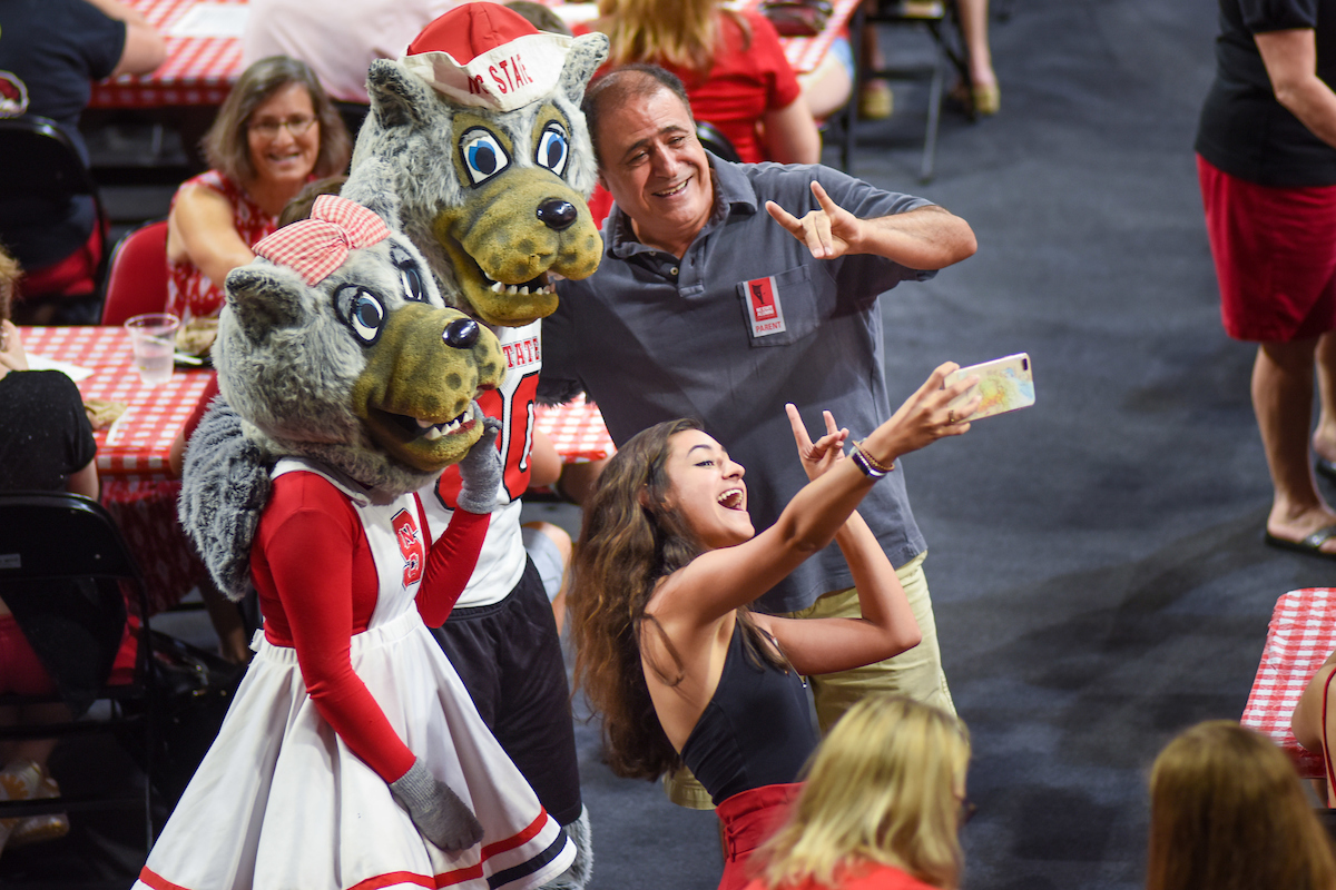 Alumni and their incoming students enjoy the festivities at the Legacy Luncheon at Reynolds Coliseum.